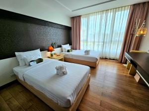 Ein Bett oder Betten in einem Zimmer der Unterkunft A-Te Chumphon Hotel - SHA Plus