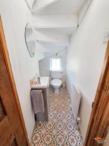 a small bathroom with a toilet and a sink at Market House Apartment - Dog Friendly in Alston