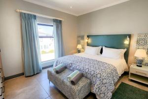 a bedroom with a large bed and a window at 10 Seaview Close, Shelley Point in St Helena Bay