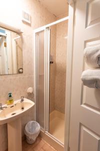 a bathroom with a shower and a sink at AVALON HOUSE in Galway