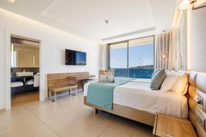 a bedroom with a large bed and a bathroom at Hotel Torre del Mar - Ibiza in Playa d'en Bossa