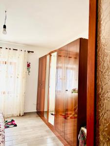 a room with a wooden closet in a room at Villa Ndoj Bukmire in Rrëshen +7 photos