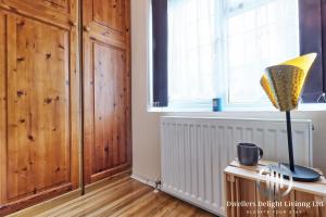 a room with a window and a lamp on a table at Stylish 3 Bedroom House Basildon/Essex Upto 5 Guests in Basildon