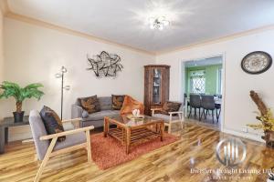 a living room with a couch and a table at Stylish 3 Bedroom House Basildon/Essex Upto 5 Guests in Basildon