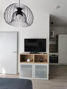 a living room with a television on a white entertainment center at Appartement's in Mayen in Mayen