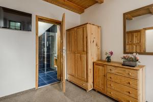 a bathroom with a wooden cabinet and a wooden dresser at Chata Bramberk in Lučany nad Nisou +95 photos