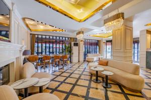 a lobby with a couch and tables and chairs at Frt Airlines Hotel - Istanbul Airport in Arnavutköy +58 photos