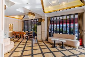 a hotel lobby with couches and a table and chairs at Frt Airlines Hotel - Istanbul Airport in Arnavutköy
