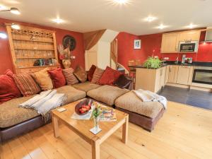 a living room with a couch and a table at Stonegarth Mews in Ambleside