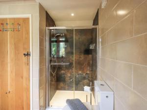 a shower with a glass door in a bathroom at Stonegarth Mews in Ambleside +16 photos