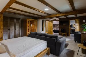 a bedroom with a bed and a couch at Chata Bramberk in Lučany nad Nisou