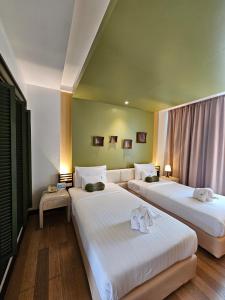 Ein Bett oder Betten in einem Zimmer der Unterkunft A-Te Chumphon Hotel - SHA Plus