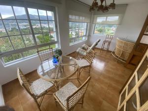 a dining room with a glass table and chairs at El Rincón de Oriona in Cedeira