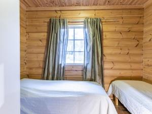 En eller flere senge i et værelse på Holiday Home Honkahovi by Interhome