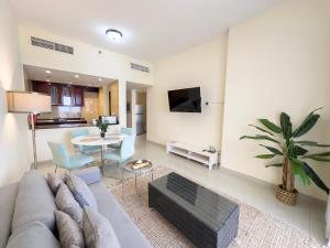 a living room with a couch and a table at Royal Breeze Sea View One Bedroom Apartment in Ras al Khaimah