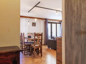 a dining room and living room with a table and chairs at Apartment Genets 150 D by Interhome in Nendaz