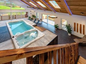 an indoor hot tub in a house with a deck at Apartment Kleiner Kessel by Interhome in Kleinsölk