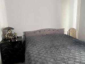 a bedroom with a bed and a dresser with a clock at Отдых в Ташире in Vorontsovka