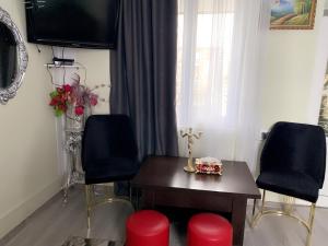 a living room with a table and two chairs at Отдых в Ташире in Vorontsovka
