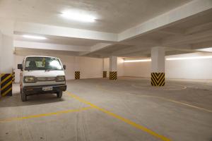 a white van parked in a parking garage at Hotel Rifaya in Porto Novo