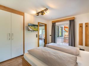 a bedroom with a bed and a sliding glass door at Apartment Grimming by Interhome in Kleinsölk +51 photos