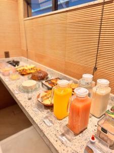 a table topped with jars of juice and plates of food at Hotel Real Cruzilia in Cruzília +3 photos