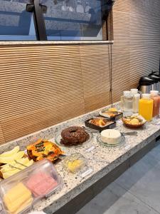 a counter with many different types of food on it at Hotel Real Cruzilia in Cruzília