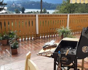 a barbecue on a patio with a table and a grill at Apartment Milly in Bled