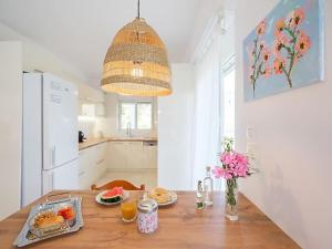a kitchen with a wooden table with food on it at Casa en Atenas in Nea Makri