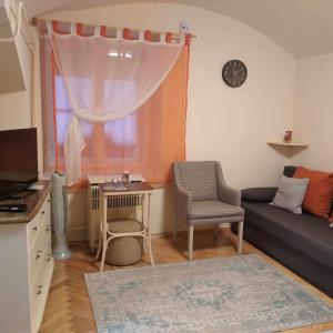 a living room with a couch and a window at Harang apartman in Szeged