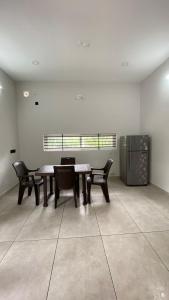 a room with a table and chairs and a window at Peaceful and Serene Space in Andūrkonam