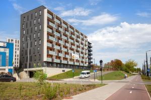 a white van parked in front of a building at Stylish Simplicity - 1BDR Cozy Stay in Vilnius in Kontverki