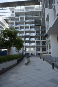 a large white building with a walkway in front of it at The Chic Retreat, Stylish Studio Close to Yas & Airport in Abu Dhabi