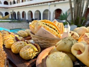 una mesa llena de pan y repostería en Pousada Puerta Del Sol Rio das Ostras, en Rio das Ostras