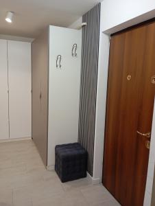 a room with a door and a stool next to a door at Apartament General in Galaţi