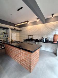 a kitchen with a brick counter in a room at Casa Papa-Vento Pousada in Lençóis +34 photos
