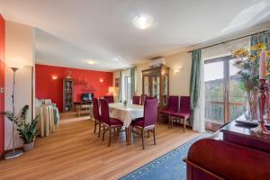 a dining room with red walls and a table and chairs at Villa Soffia with Private Pool in Pazin