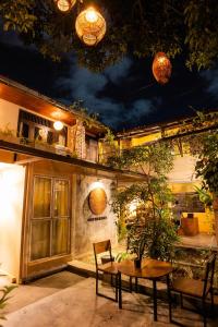 a patio with a table and chairs and lights at Drop Inn Hostels in Colombo