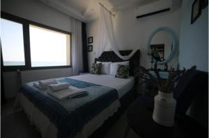 a bedroom with a bed with towels on it at Bambu Urla Otel in Urla