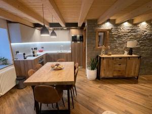 a kitchen and dining room with a wooden table at La Casetta in Gressan