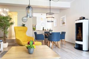 a living room with a yellow chair and a table at FeWo Muschelsucher in Wustrow