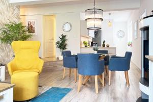 a kitchen and dining room with a yellow dining table and chairs at FeWo Muschelsucher in Wustrow +6 photos