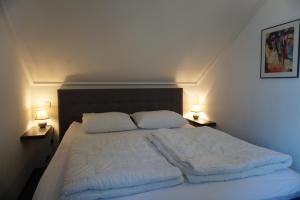 a bedroom with a large bed with two pillows at Kustverhuur, Vakantiepark Fort Soleil 24 in Breskens
