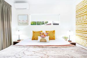 a bedroom with a large bed and two lamps at 12 Central Plaza Port Douglas in Port Douglas +7 photos