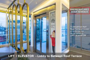 a poster of a woman standing in a revolving door at Best Point Hotel Sultanahmet,Istanbul in Istanbul