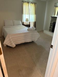 a bedroom with a bed and a window at Serenity Retreat near Camp Lejeune & Beaches in Jacksonville