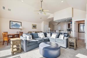 a living room with a blue couch and a table at 2 Collier Beach- Oceanfront, Dog Friendly , Private Pool, FREE Activities in Hilton Head Island