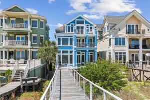 a row of houses on the beach with a boardwalk at 2 Collier Beach- Oceanfront, Dog Friendly , Private Pool, FREE Activities in Hilton Head Island