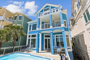 a house with a pool in front of it at 2 Collier Beach- Oceanfront, Dog Friendly , Private Pool, FREE Activities in Hilton Head Island