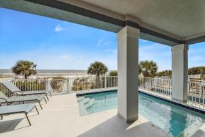 a view of the pool and beach from the balcony of a resort at 27 Singleton Beach- Oceanfront, Private Pool, Pool Table, FREE Activities Included in Hilton Head Island